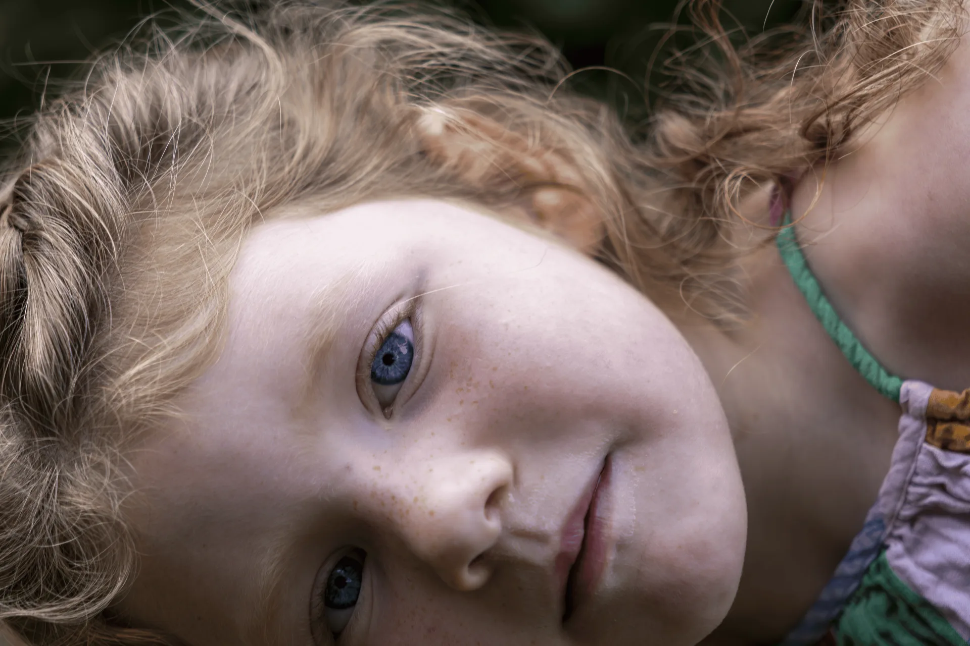 Close-up portrait of a young girl with curly hair