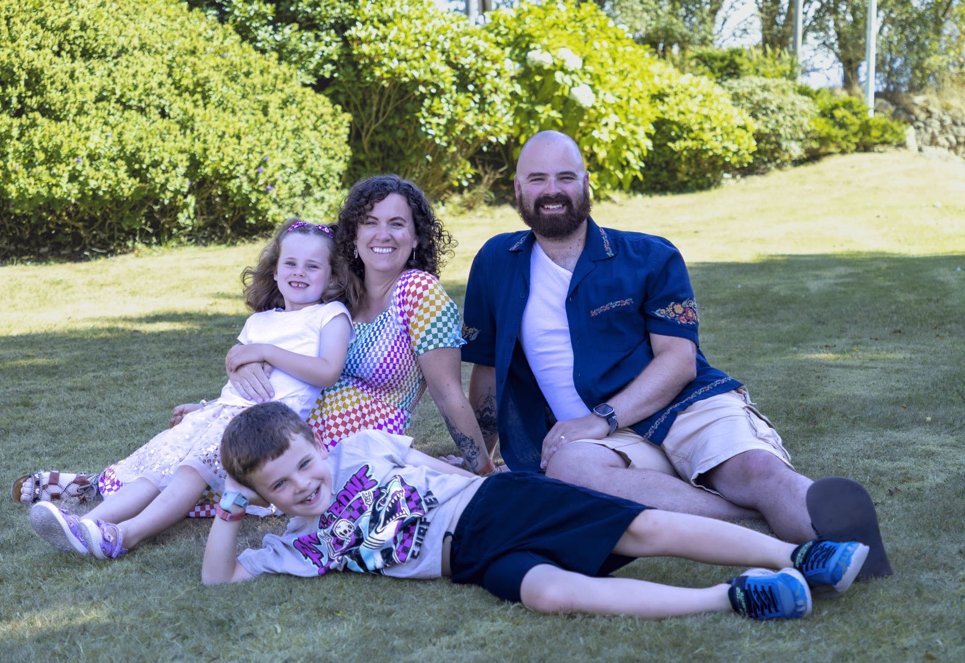 Family of four relaxing together on the grass